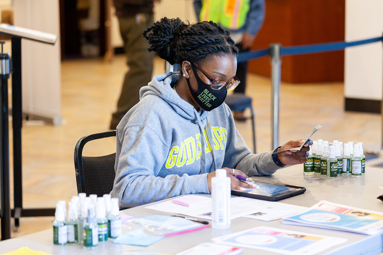 Krystal Smith registers a community member for the COVID-19 vaccine at a vaccination site at The Church of God of East New York. Image courtesy of Stop the Spread