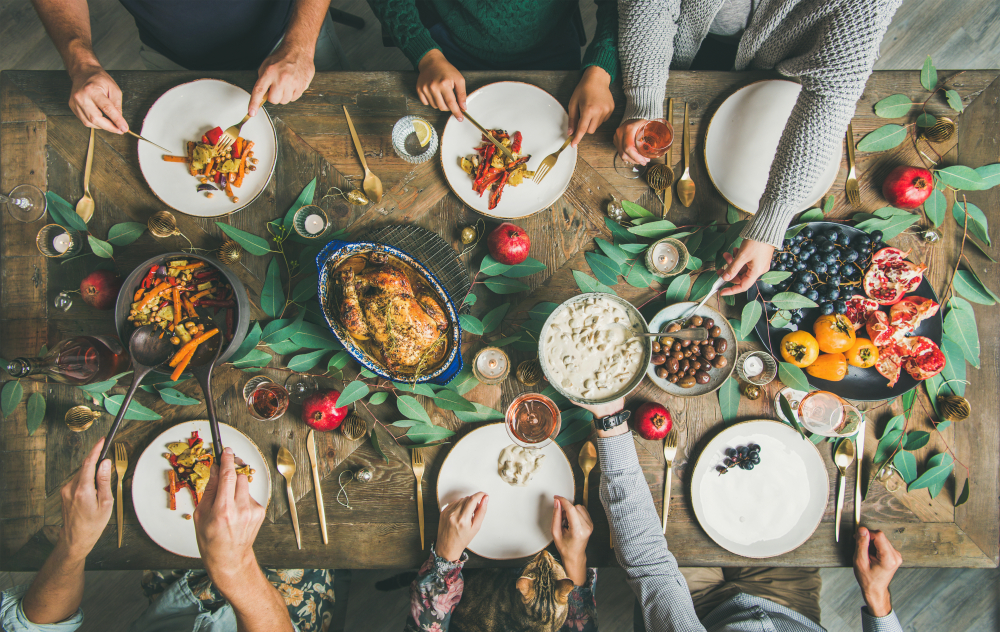 Holiday spread with people serving themselves food.