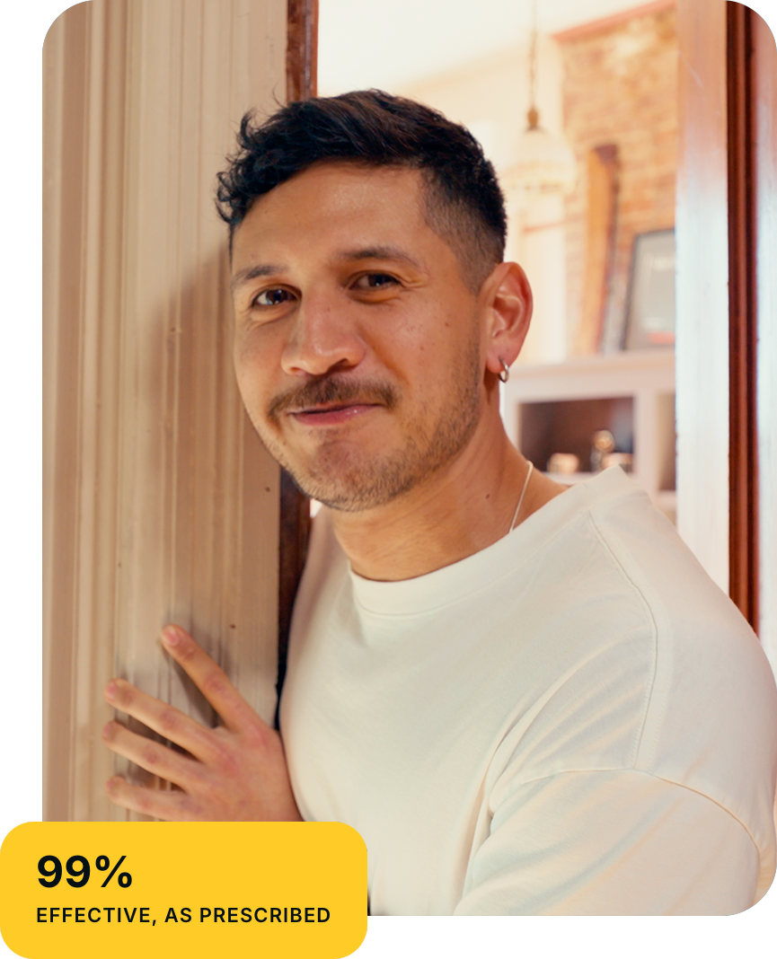 A smiling person standing in a doorway